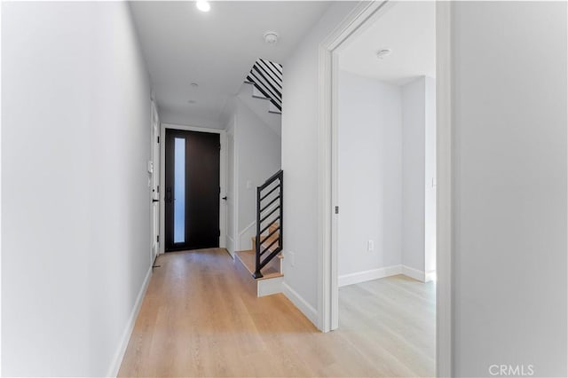 hallway with light hardwood / wood-style flooring