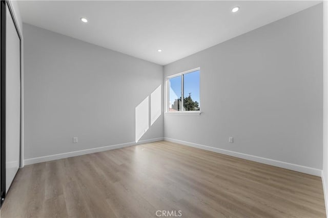 unfurnished room with light wood-type flooring