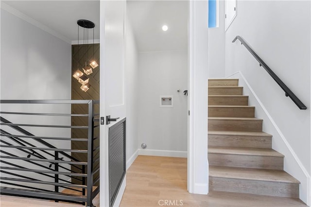 stairway featuring crown molding and hardwood / wood-style floors