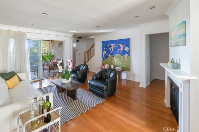 living room with hardwood / wood-style flooring and ornamental molding