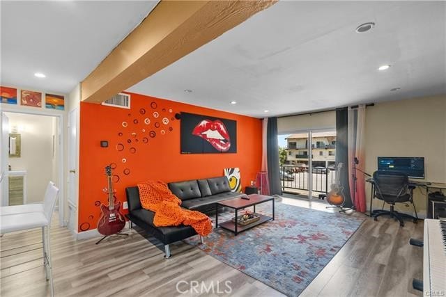 living room with beam ceiling and hardwood / wood-style flooring