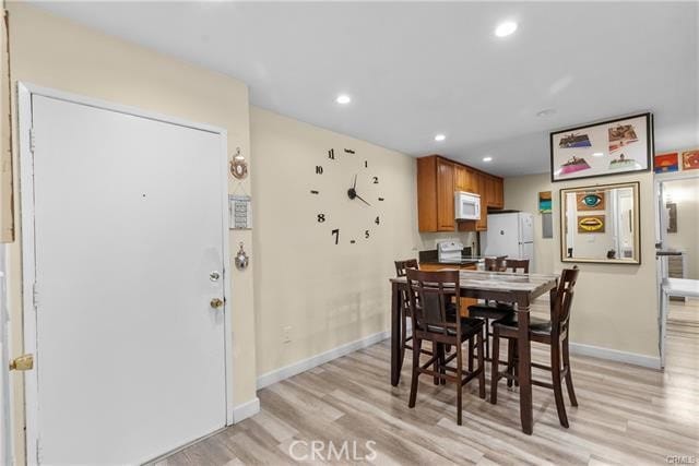 dining space with light hardwood / wood-style flooring