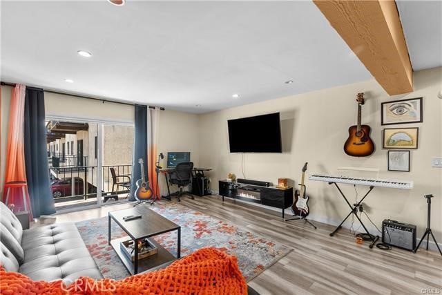 living room featuring light hardwood / wood-style flooring and beamed ceiling