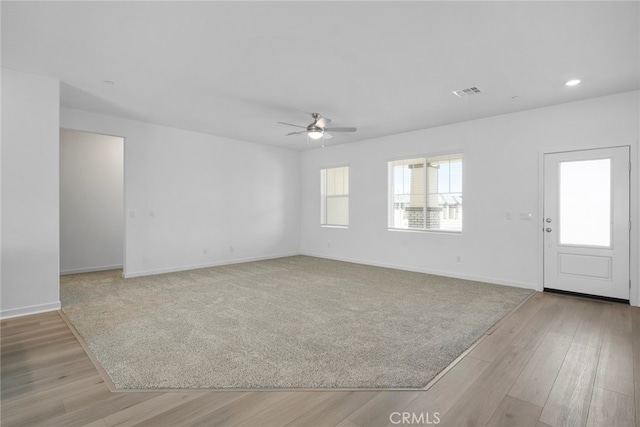 empty room featuring light hardwood / wood-style flooring and ceiling fan