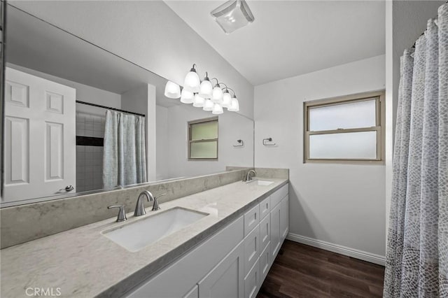 bathroom with a shower with shower curtain, hardwood / wood-style floors, and vanity