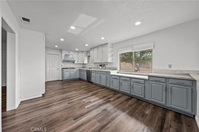 kitchen featuring dishwasher, premium range hood, dark hardwood / wood-style floors, and gray cabinetry