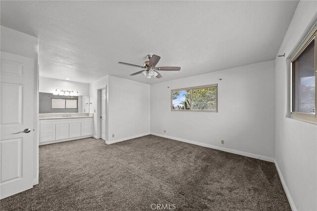 carpeted spare room with ceiling fan