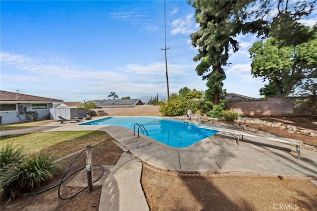 view of pool with a patio area and a diving board