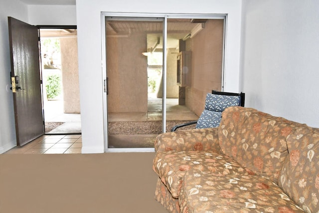 interior space featuring light tile patterned flooring, multiple windows, and a closet