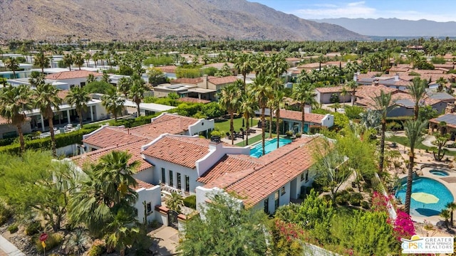 birds eye view of property with a mountain view