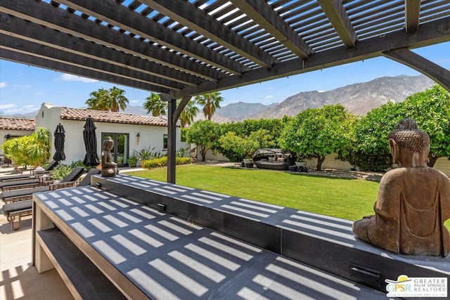 view of patio / terrace with a pergola and a mountain view