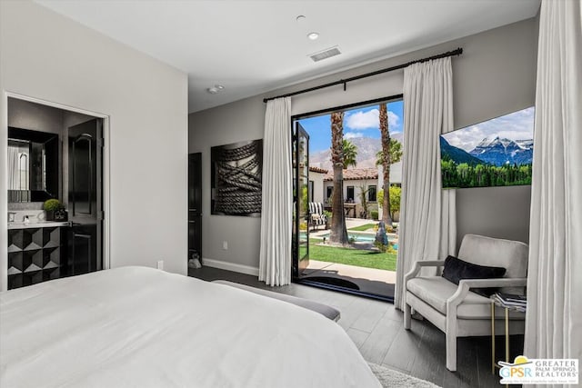 bedroom featuring access to exterior and wood-type flooring