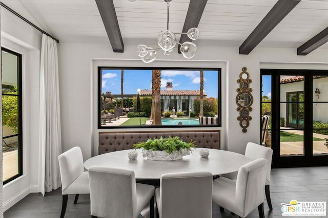 dining room featuring beam ceiling and a chandelier