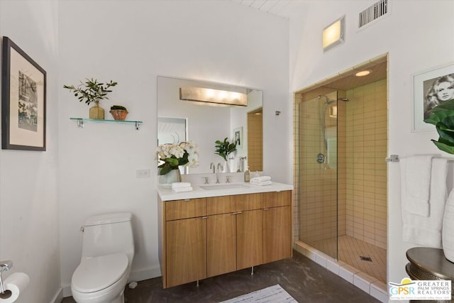 bathroom featuring a shower with shower door, toilet, and vanity