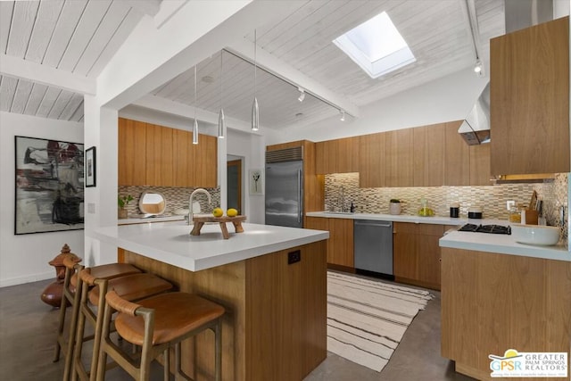 kitchen with pendant lighting, appliances with stainless steel finishes, wood ceiling, a kitchen island, and decorative backsplash