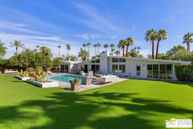 back of property with a patio area, outdoor lounge area, and a lawn