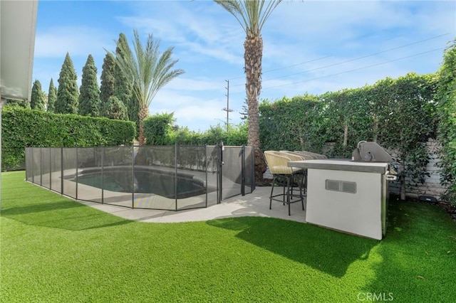 exterior space with a fenced in pool, a patio area, a yard, and a bar