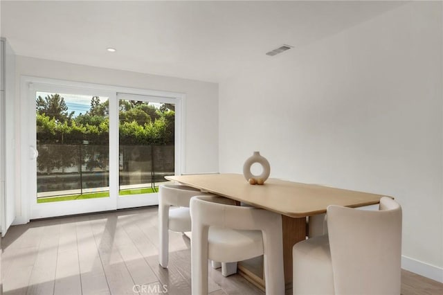 unfurnished dining area featuring light wood-type flooring