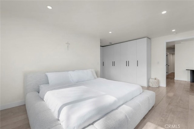 bedroom featuring light hardwood / wood-style floors and a closet