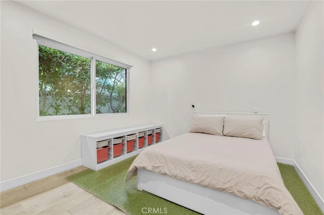 bedroom with hardwood / wood-style flooring