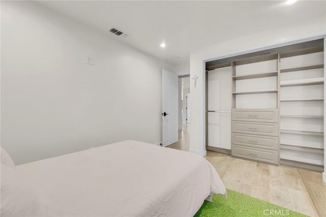 bedroom featuring light wood-type flooring and a closet