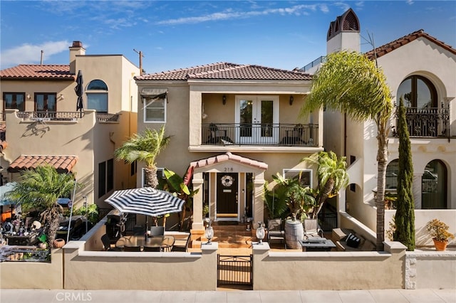 mediterranean / spanish-style house featuring a balcony and a patio