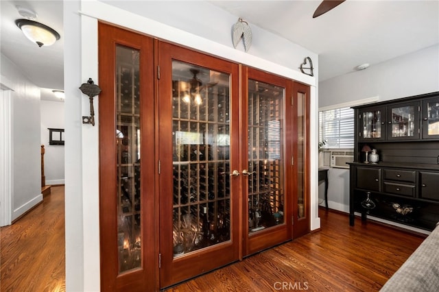 wine room featuring dark wood-type flooring and cooling unit