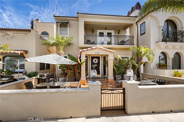 mediterranean / spanish-style home with a balcony