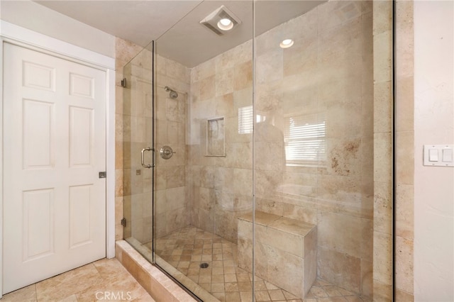 bathroom featuring a shower with shower door