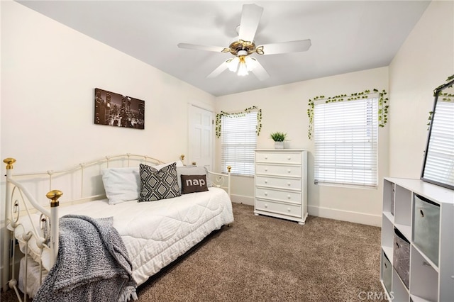 bedroom featuring ceiling fan and dark carpet