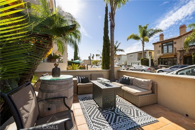 view of patio with an outdoor living space with a fire pit