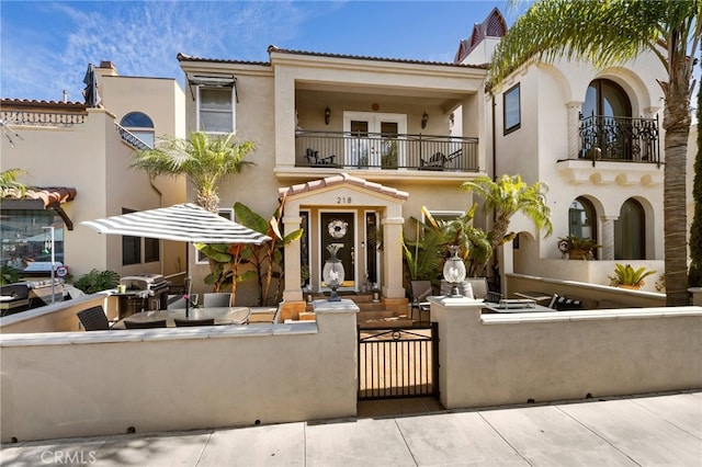 mediterranean / spanish-style house featuring a patio and a balcony