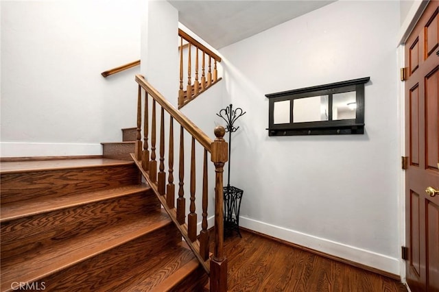 stairs with wood finished floors and baseboards