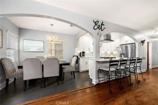 dining room featuring dark wood-type flooring and a notable chandelier