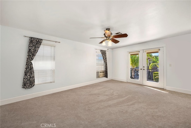 spare room featuring light carpet and baseboards