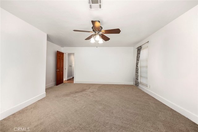 empty room with baseboards, a ceiling fan, visible vents, and light colored carpet