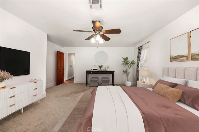 bedroom with a ceiling fan, visible vents, light carpet, and baseboards