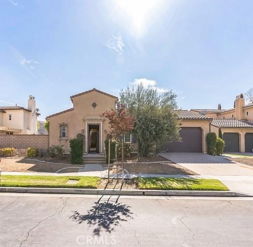 mediterranean / spanish home with a garage