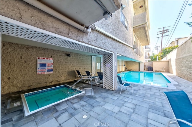 view of swimming pool with a patio