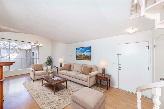 living room featuring hardwood / wood-style floors and an inviting chandelier