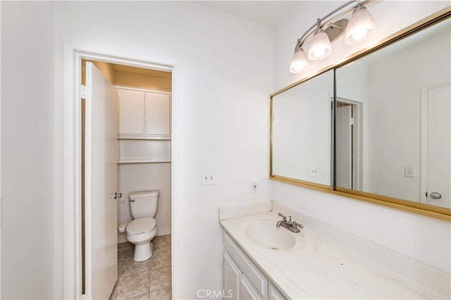 bathroom featuring toilet, vanity, and tile patterned floors