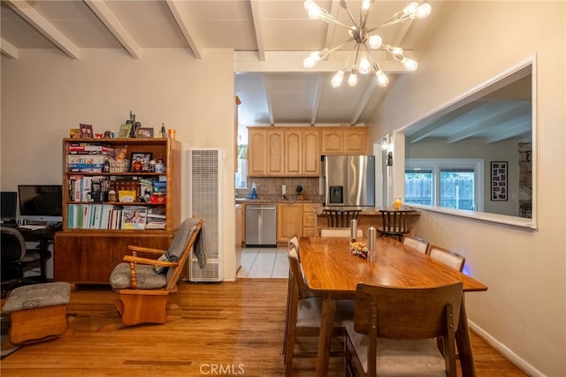 13503 Fidler Ave, Bellflower, CA 90706 - dining area featuring a heating unit, beamed ceiling, a chandelier, and light wood-style flooring
