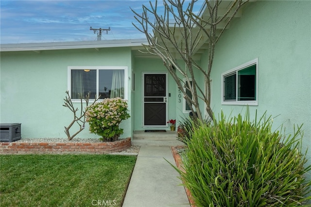 13503 Fidler Ave, Bellflower, CA 90706 - property entrance featuring stucco siding and a lawn