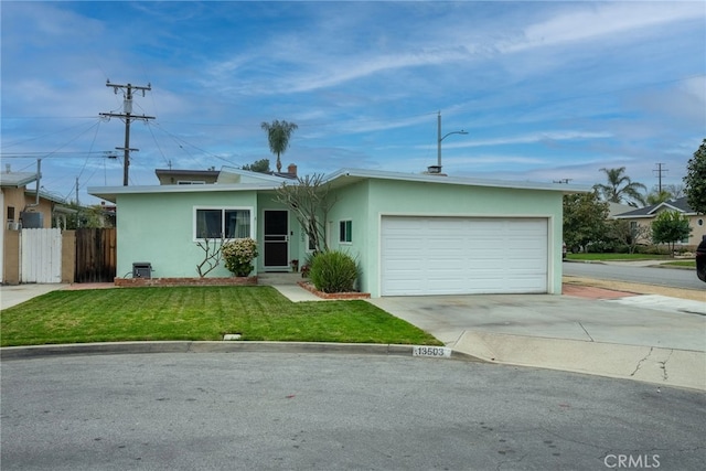 13503 Fidler Ave, Bellflower, CA 90706 - view of front facade with stucco siding, concrete driveway, and an attached garage
