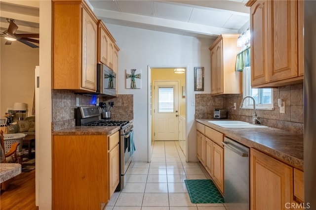 13503 Fidler Ave, Bellflower, CA 90706 - kitchen with stainless steel appliances, a ceiling fan, decorative backsplash, beamed ceiling, and light tile patterned floors