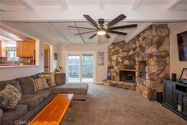 13503 Fidler Ave, Bellflower, CA 90706 - living room featuring a ceiling fan, carpet flooring, beam ceiling, and a stone fireplace