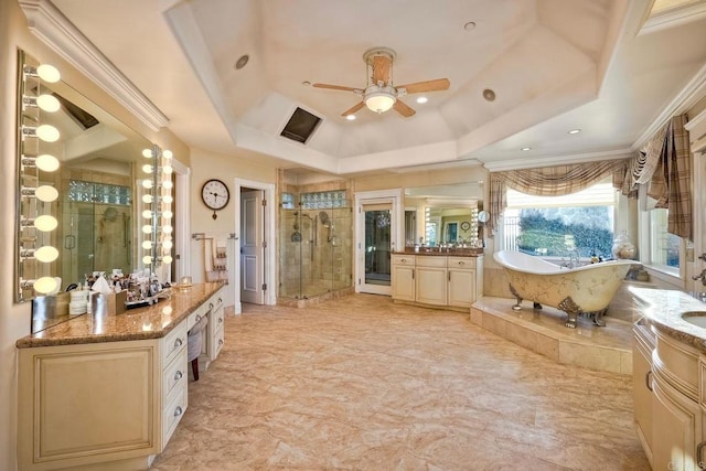 bathroom with ceiling fan, plus walk in shower, a raised ceiling, vanity, and ornamental molding