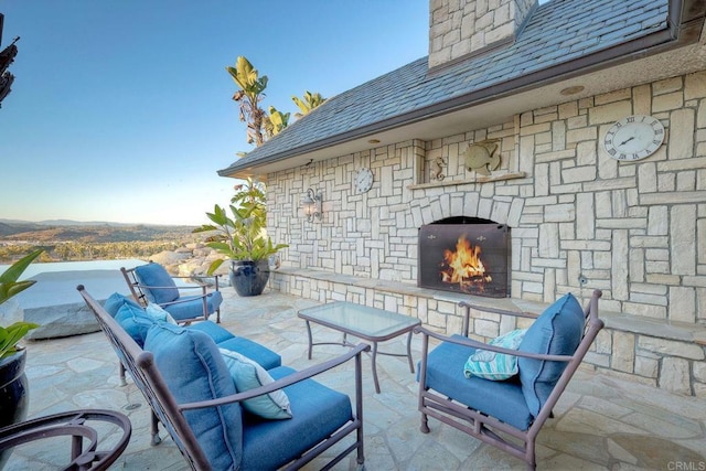 view of patio / terrace with an outdoor stone fireplace