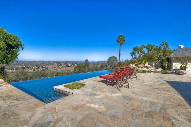 view of swimming pool with a patio area