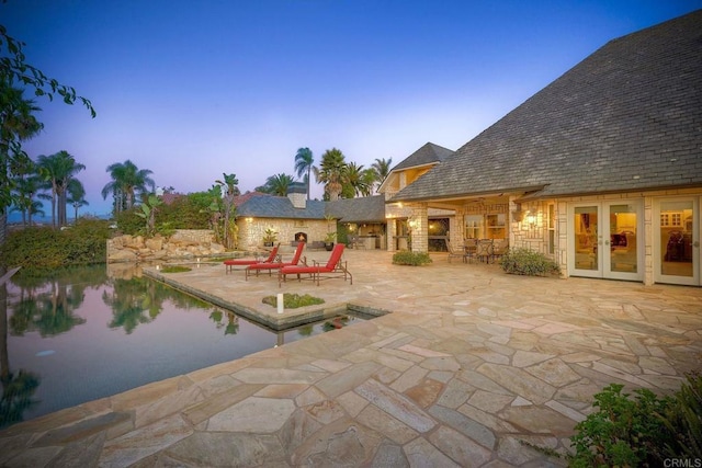 31350 Lake Vista Cir, Bonsall, CA 92003 - patio terrace at dusk featuring french doors, a patio area, and an outdoor pool